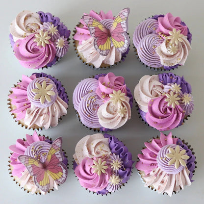 Pink and purple enchanted theme cupcakes decorated with delicate piping, flowers, butterflies, sugar pearls