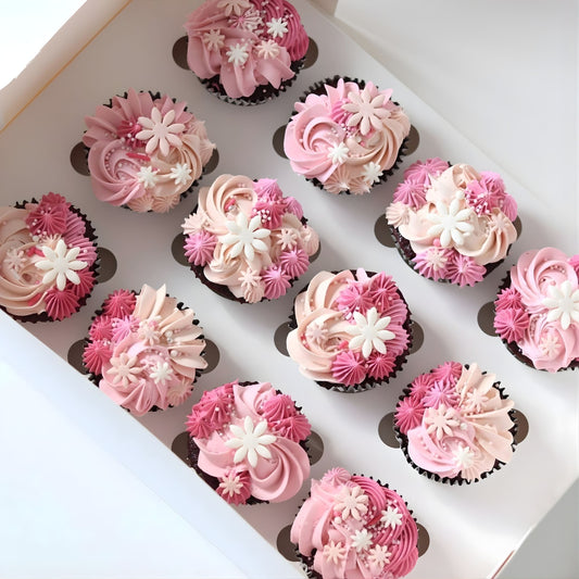 Fancy pink piped cupcakes with delicate flowers