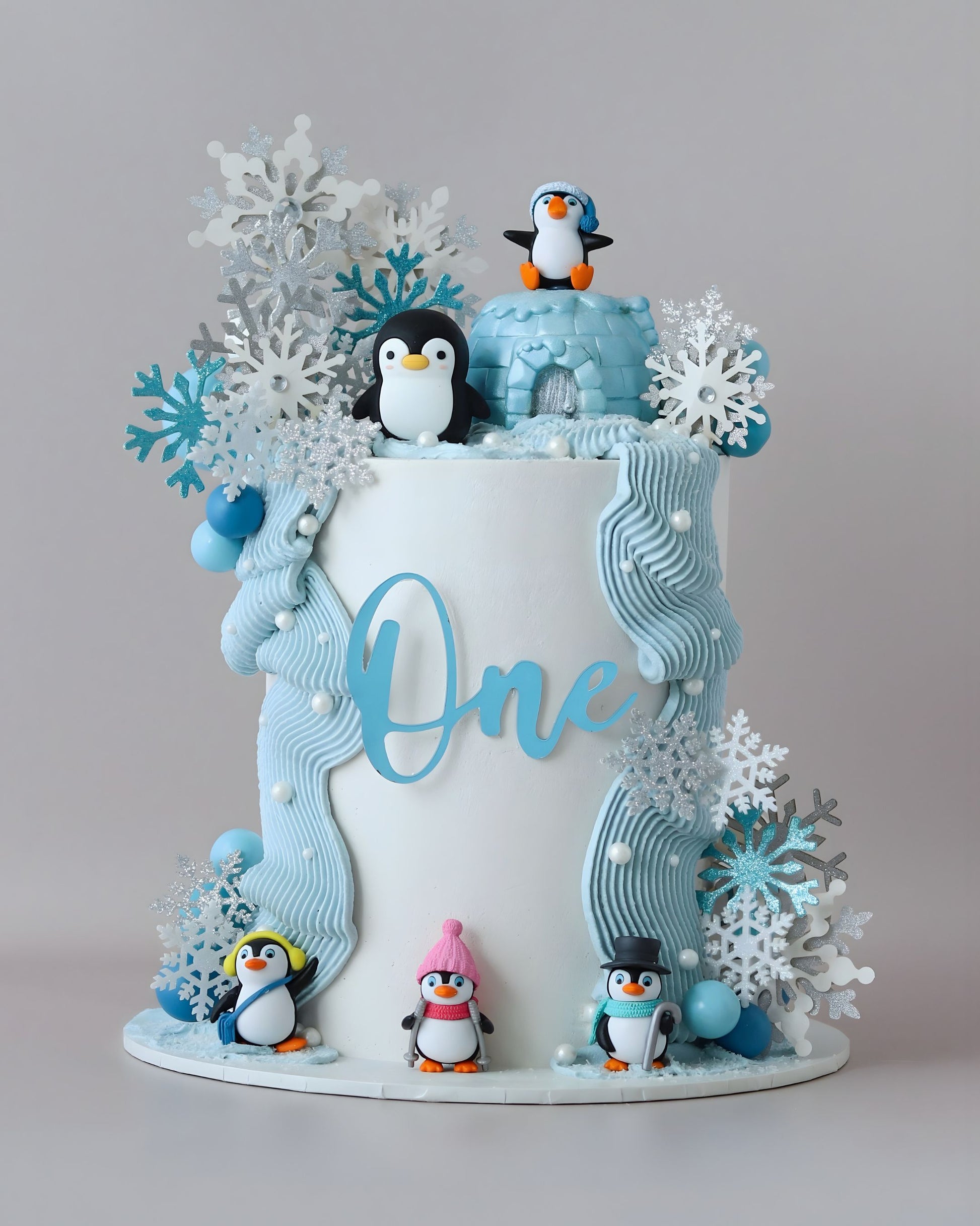 Blue & white penguin theme cake with snowflakes