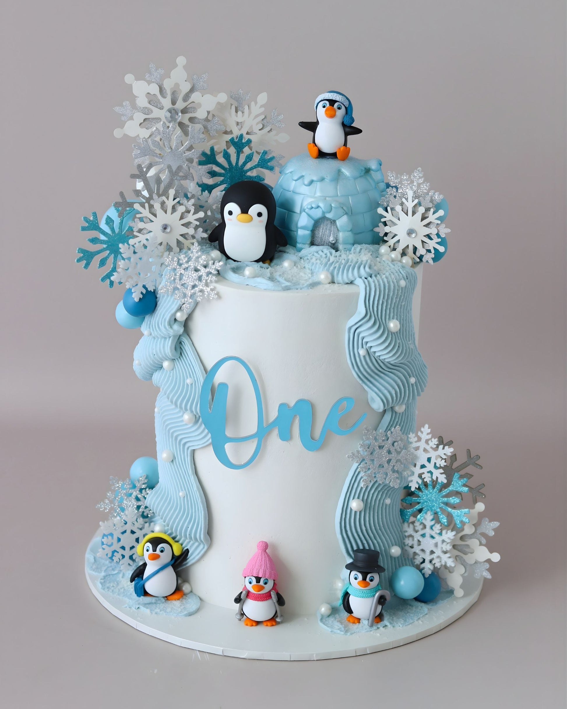 Blue & white penguin theme cake with snowflakes